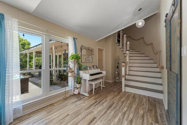 a view of a hallway with wooden floor and entryway