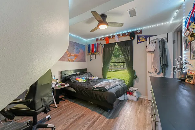 a bedroom with a bed and a chandelier