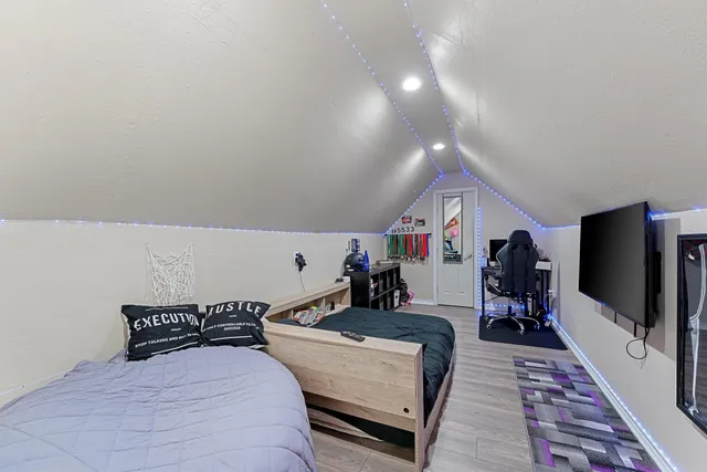 a bed room with two bed and a flat screen tv