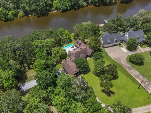 an aerial view of ocean residential house with outdoor space and trees all around