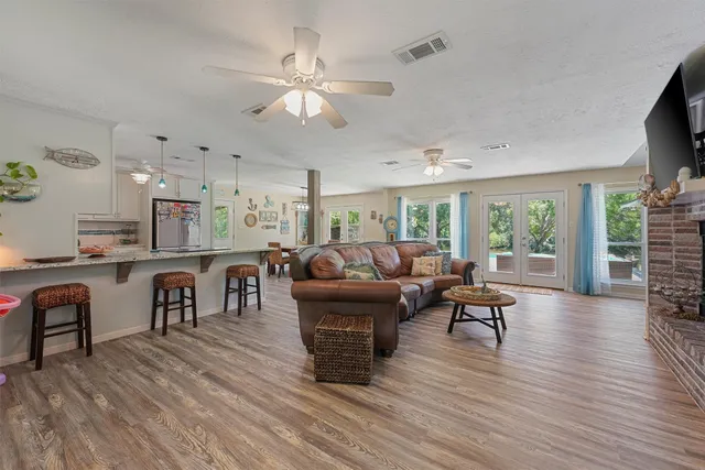 a living room with furniture and a wooden floor