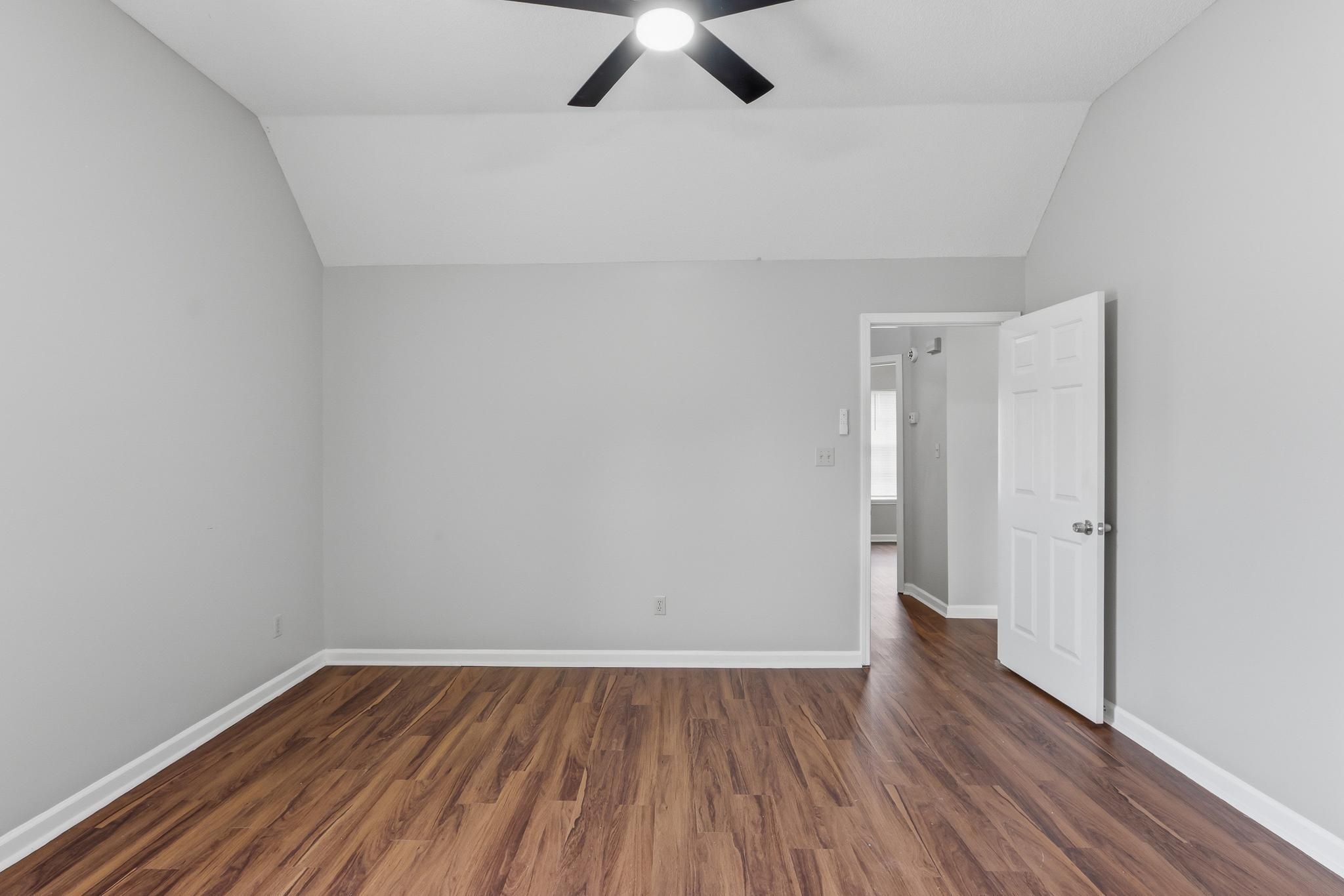 4101 Long Creek Road Memphis, TN 38125 - Photo 18 of 36 Vaulted ceiling room featuring wood-finish flooring, light gray wall paint, and white baseboards