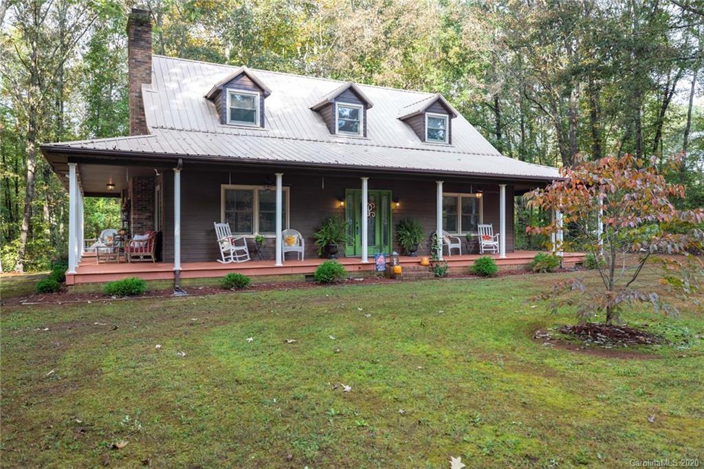 a view of a house with backyard porch and sitting area