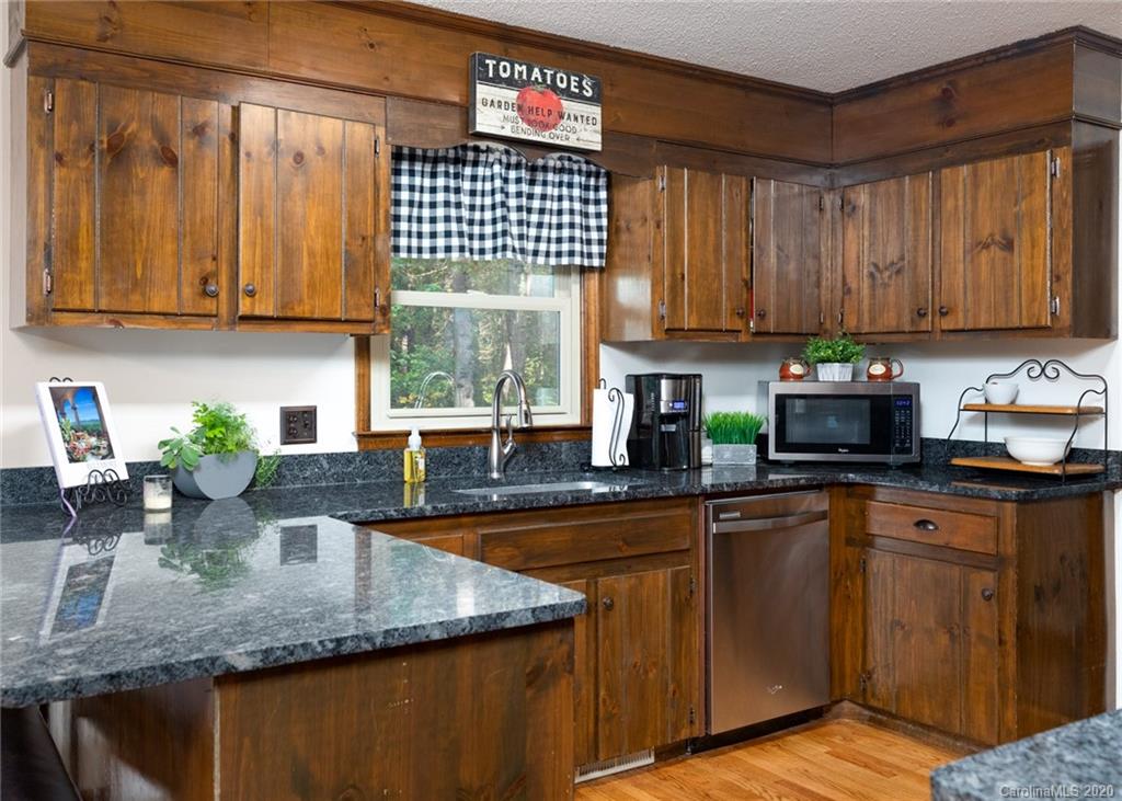 345 Whiteside Road Clover, SC 29710 - Photo 16 of 46 a kitchen with stainless steel appliances granite countertop a sink a counter space and cabinets