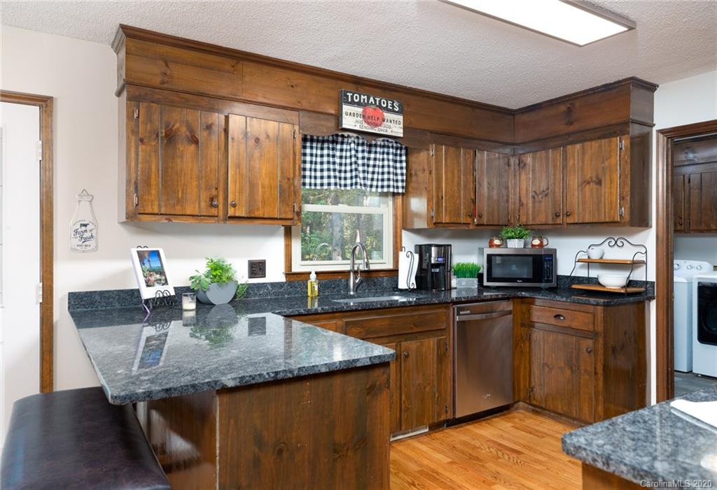 345 Whiteside Road Clover, SC 29710 - Photo 18 of 46 a kitchen with granite countertop kitchen island stainless steel appliances a sink window and cabinets