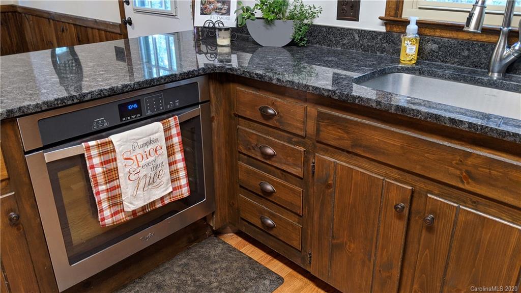 345 Whiteside Road Clover, SC 29710 - Photo 21 of 46 a kitchen with granite countertop a sink stove and cabinets
