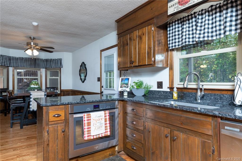 345 Whiteside Road Clover, SC 29710 - Photo 23 of 46 a kitchen with stainless steel appliances granite countertop a sink a stove and a wooden cabinets
