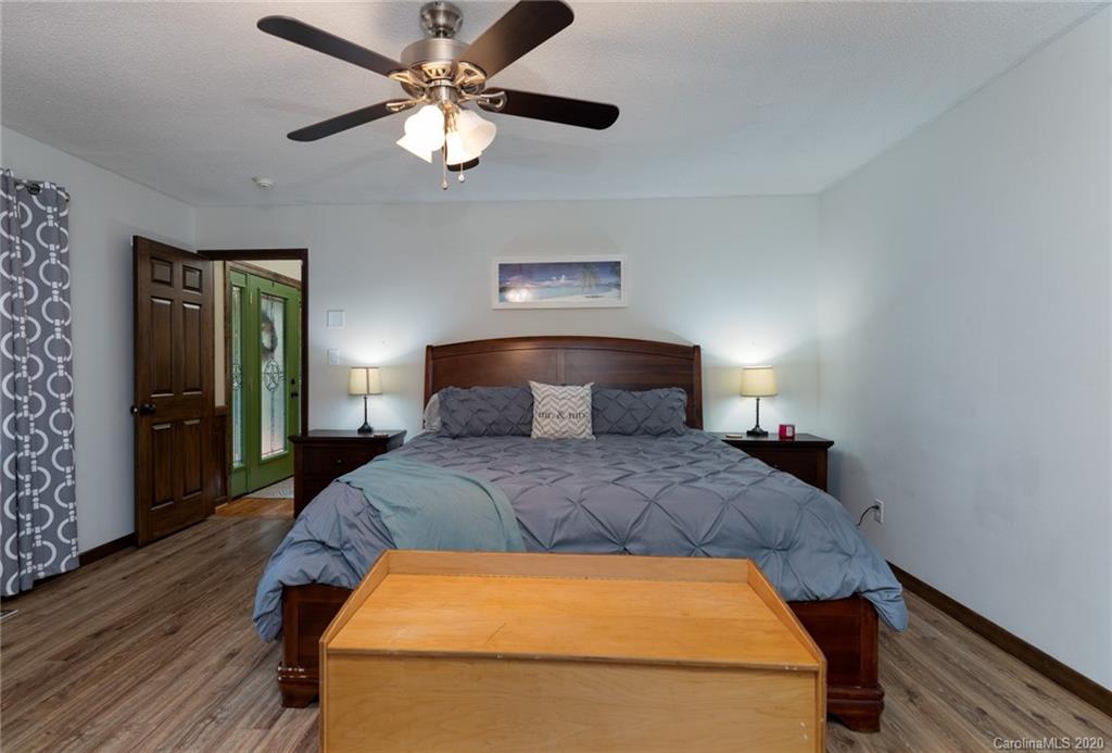 345 Whiteside Road Clover, SC 29710 - Photo 26 of 46 a bedroom with a bed and a chandelier