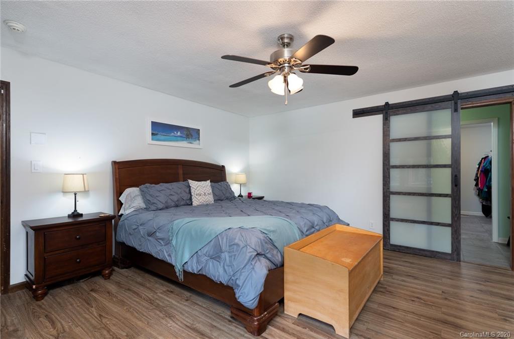 345 Whiteside Road Clover, SC 29710 - Photo 27 of 46 a bedroom with a bed and a chandelier