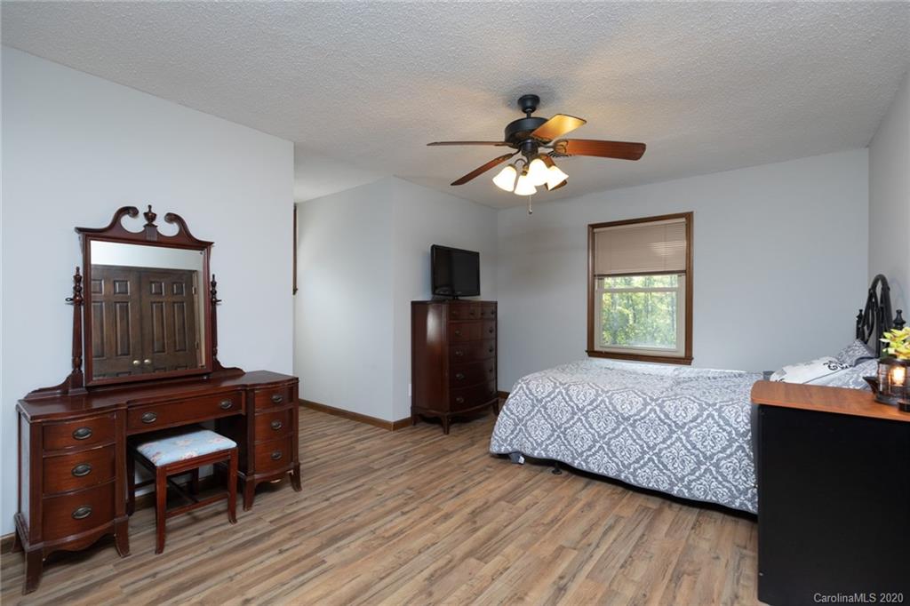 345 Whiteside Road Clover, SC 29710 - Photo 33 of 46 a bedroom with a bed and a chandelier