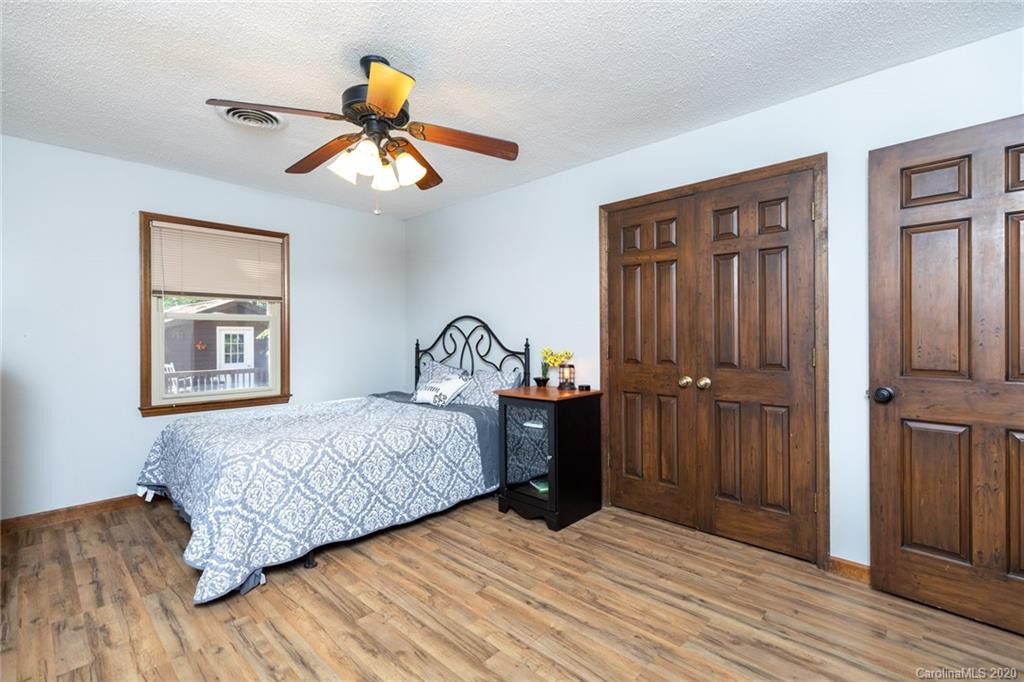 345 Whiteside Road Clover, SC 29710 - Photo 34 of 46 a bedroom with a bed and a chandelier