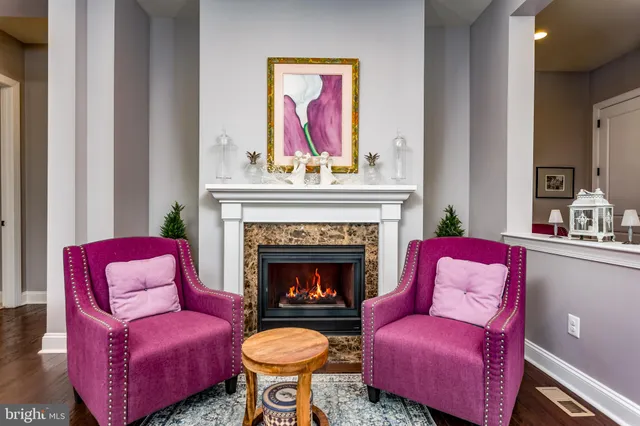 a living room with furniture a flat screen tv and wooden floor