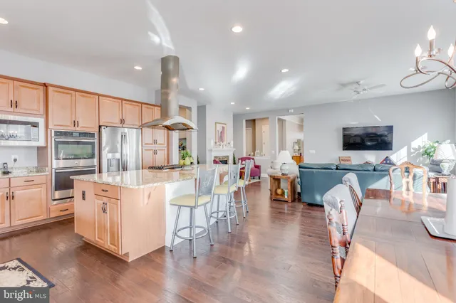a kitchen with a table chairs refrigerator and cabinets