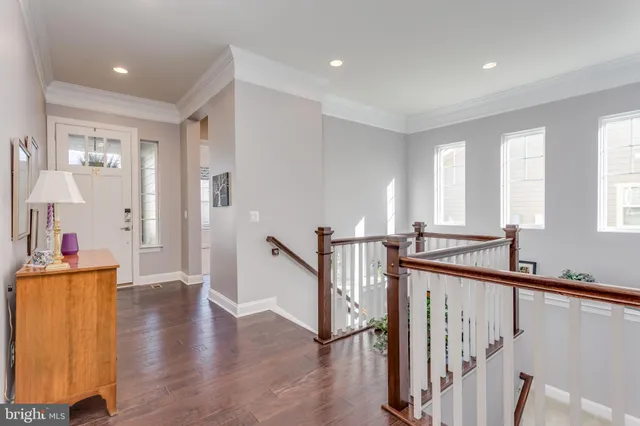 a view of a hallway with workspace and staircase