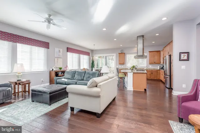 a living room with furniture potted plant and a window