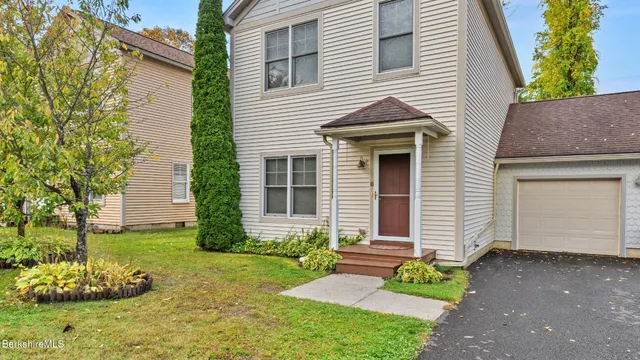 a front view of a house with a garden