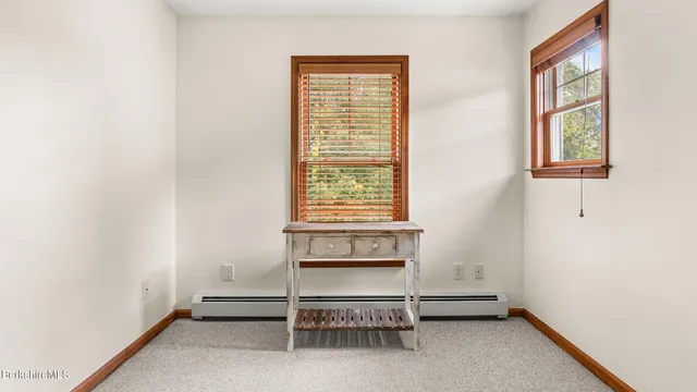 a room with a window and a ceiling fan