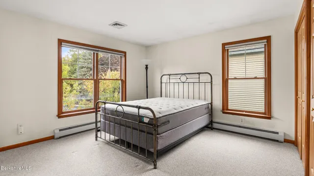 a bed sitting in a bedroom next to a window