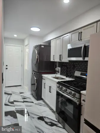 a kitchen with a stove and a sink