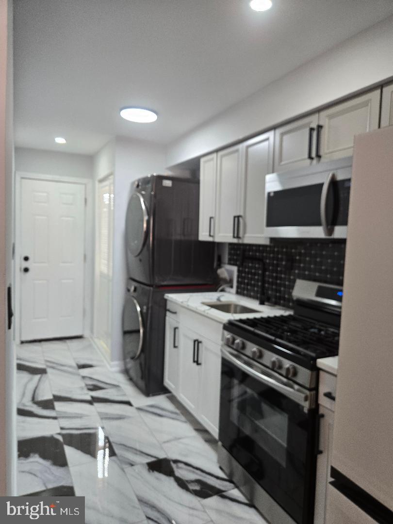 5433 C Street Southeast, Unit 2 Washington, DC 20019 - Photo 3 of 7 a kitchen with a stove and a sink