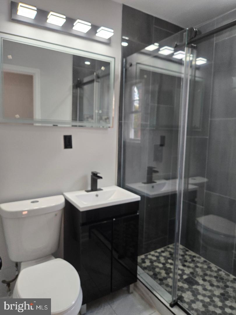 5433 C Street Southeast, Unit 2 Washington, DC 20019 - Photo 6 of 7 a bathroom with a sink toilet and shower