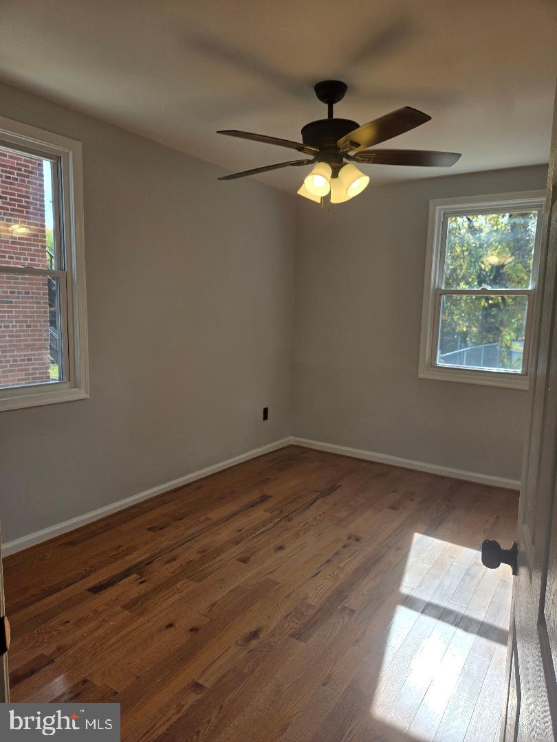 5433 C Street Southeast, Unit 2 Washington, DC 20019 - Photo 7 of 7 a view of empty room with wooden floor and fan