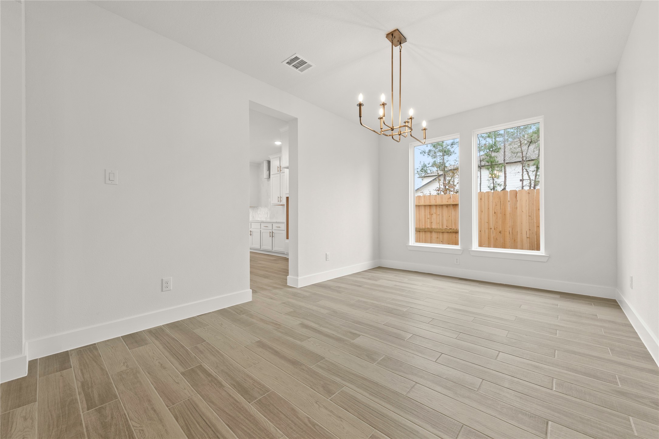 18917 Moonriver Street Conroe, TX 77302 - Photo 7 of 28 a view of an empty room with wooden floor and a window