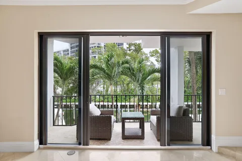 a view of a kitchen with kitchen island stainless steel appliances a sink and a living room view