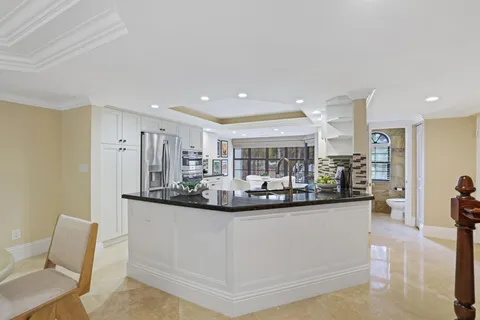 a kitchen with sink and lots of white cabinet