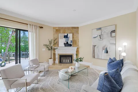 a living room with furniture large window and a fireplace