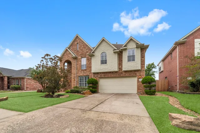 a front view of a house with a yard and garage
