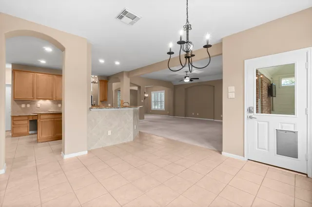 a view of a kitchen center island and stainless steel appliances