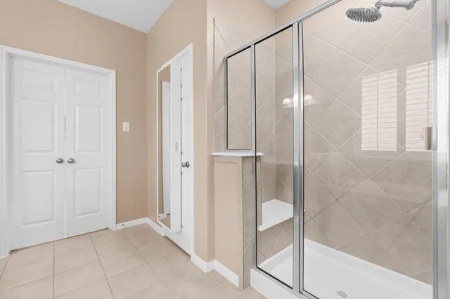 a bathroom with a glass shower door