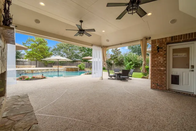 a view of a livingroom with furniture and floor to ceiling window