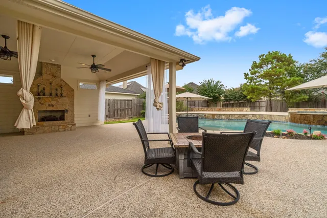 a view of a patio with table and chairs and potted plants