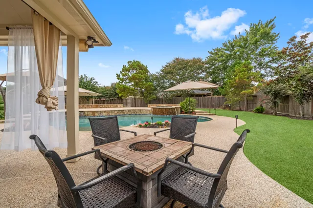 a patio with table and chairs