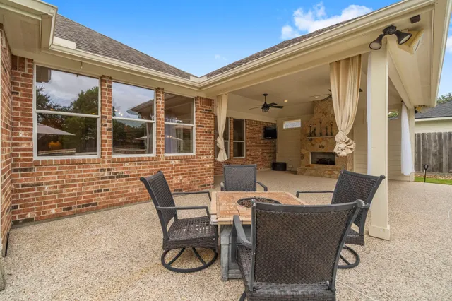 a view of a patio with table and chairs