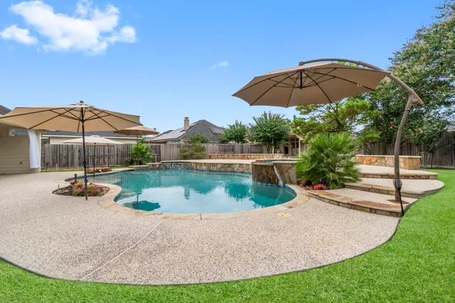 a view of a house with swimming pool and sitting area