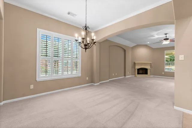 a view of livingroom and a chandelier fan