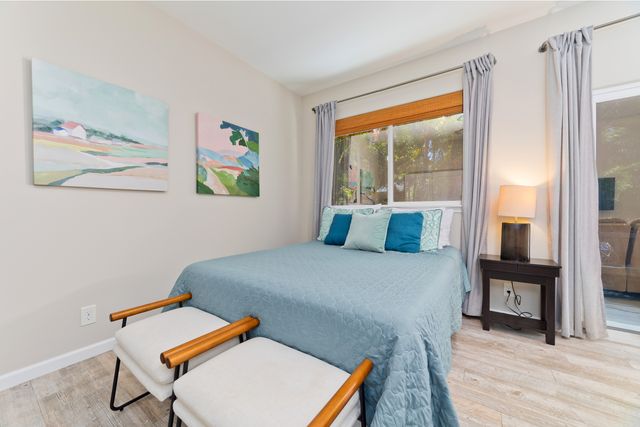 a bed sitting in a room next to a window