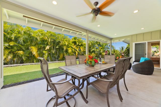 a view of a dining room with furniture and a floor to ceiling window