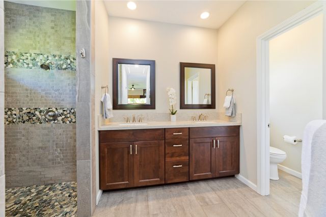 a bathroom with a double vanity sink and a mirror