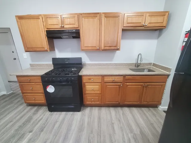 a kitchen with a sink and cabinets