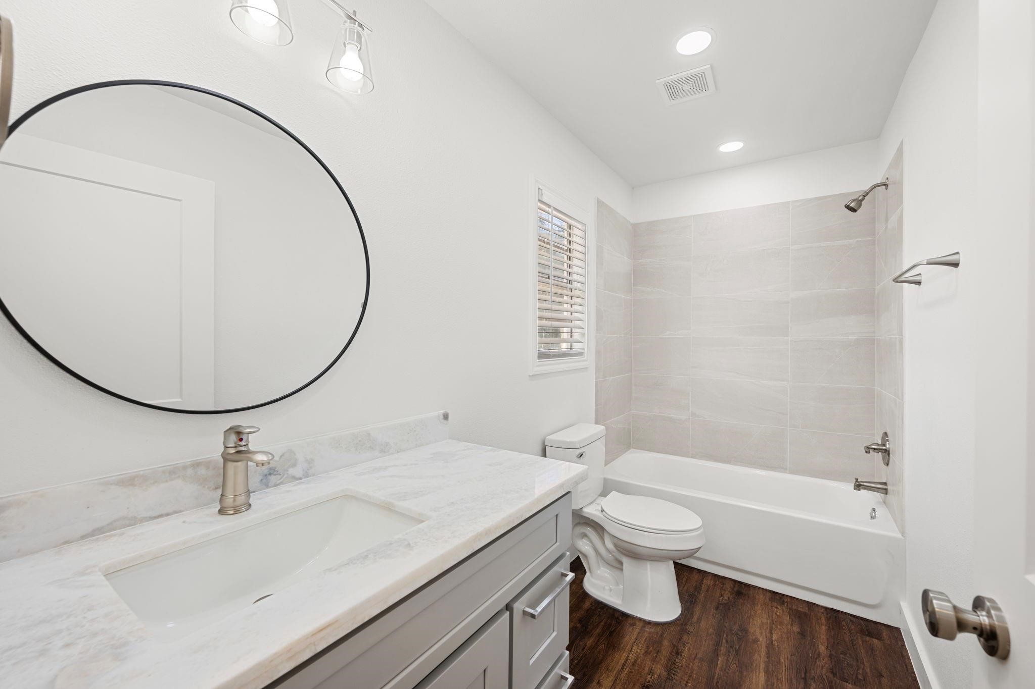 11610 Palmsprings Drive Houston, TX 77034 - Photo 11 of 23 a bathroom with a sink a toilet and a mirror