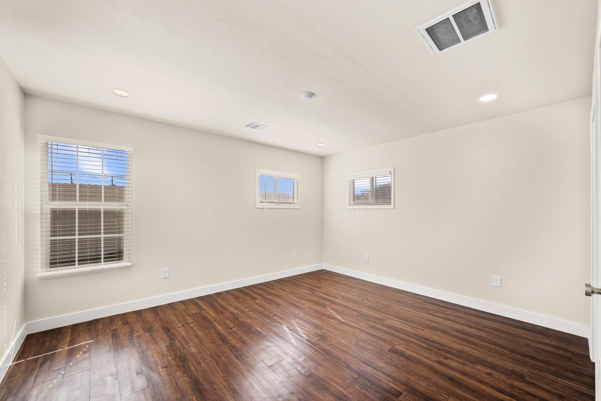 11610 Palmsprings Drive Houston, TX 77034 - Photo 10 of 23 an empty room with wooden floor and windows