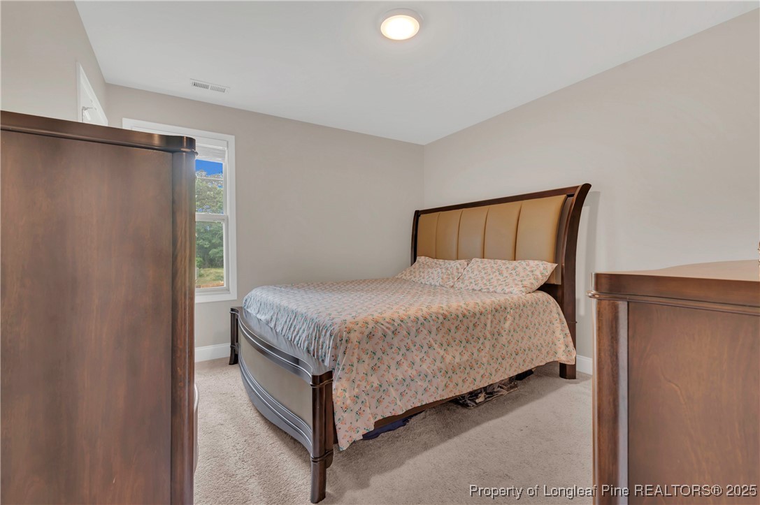 5145 Maxwell Road Stedman, NC 28391 - Photo 20 of 35 a bed sitting in a bedroom next to a bathroom