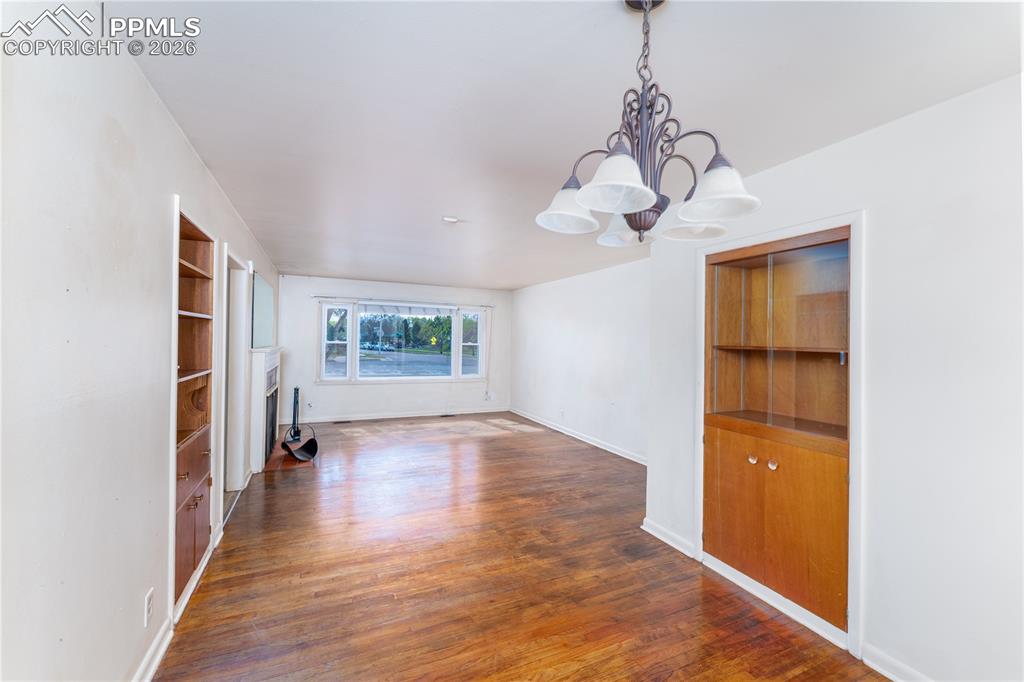 2818 Templeton Gap Road Colorado Springs, CO 80907 - Photo 4 of 27 a view of an empty room with wooden floor and windows