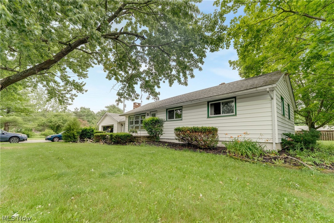 White siding exterior with green trim accents