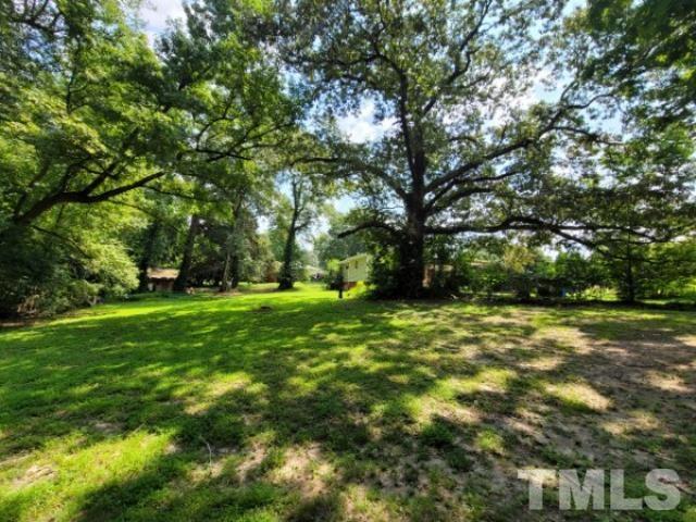 5320 Rock Quarry Road Raleigh, NC 27610 - Photo 2 of 13 a view of a field with trees