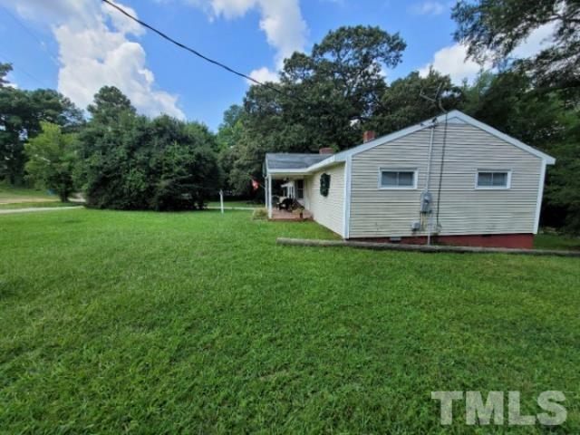 5320 Rock Quarry Road Raleigh, NC 27610 - Photo 5 of 13 a view of a backyard with large trees and plants